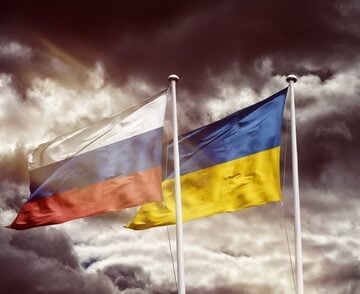 The national flags of Russia and Ukraine against a stormy, dramatic background, symbolizing the ongoing conflict between the two nations. The national flags of Russia and Ukraine against a stormy, dramatic background, symbolizing the ongoing conflict between the two nations.