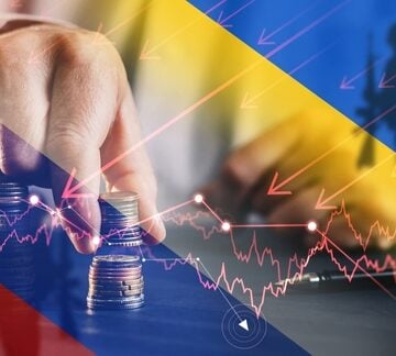 Conceptual illustration depicting the economic impact of conflict, featuring financial graphs, stacked coins, and a silhouette of a soldier against a backdrop resembling the Ukrainian flag colors. Conceptual illustration depicting the economic impact of conflict, featuring financial graphs, stacked coins, and a silhouette of a soldier against a backdrop resembling the Ukrainian flag colors.