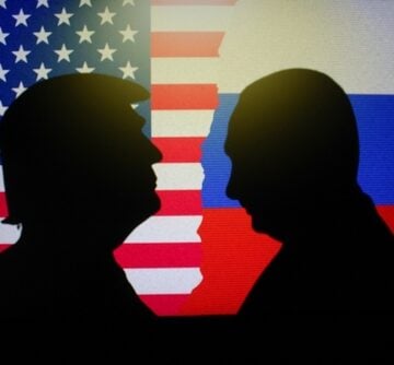 The silhouettes of Donald Trump and Vladimir Putin facing each other in front of the U.S. and Russian flags. The silhouettes of Donald Trump and Vladimir Putin facing each other in front of the U.S. and Russian flags.