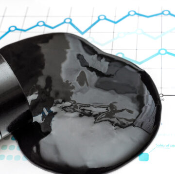 Concept image of crude oil spilling out of a small barrel onto financial market charts and graphs. Concept image of crude oil spilling out of a small barrel onto financial market charts and graphs.