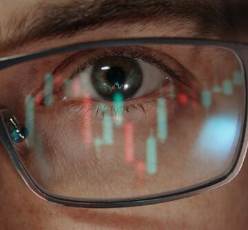 Close-up,Of,A,Crypto,Trader,Or,Investor,Eye,With,Candlestick THE “GREAT DIVERGENCE” WIPE-OUT OF THE U.S. ECONOMY WORSENS… (AS THE STOCK MARKET CONTINUES TO CLIMB)