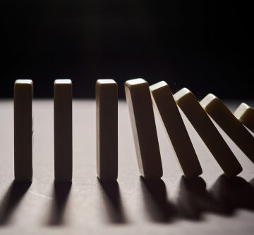 Falling,Dominoes,Black,Background THE VANISHING VILLAGE – MEMORY, ELDERS, AND THE DEATH OF CONSEQUENCE (Part IV)