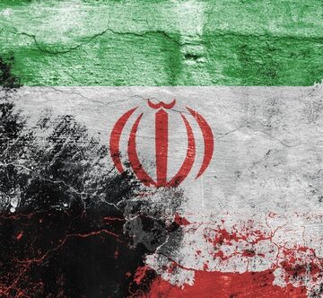 This image shows a weathered, distressed rendition of the national flag of the Islamic Republic of Iran, featuring the green, white, and red horizontal tricolor with the red national emblem centered in the white band.