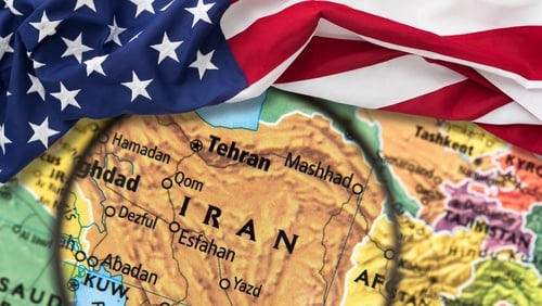 A conceptual map focusing on Iran overlaid with an American flag. A conceptual map focusing on Iran overlaid with an American flag.