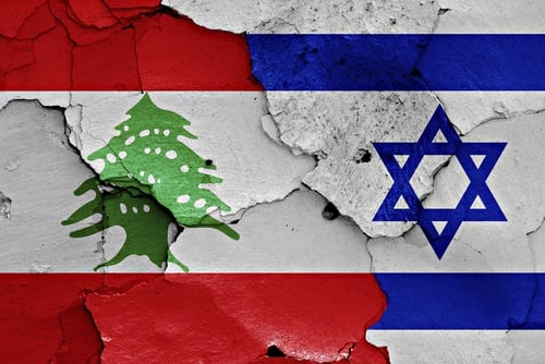 The national flags of Lebanon and Israel separated by a cracks. The national flags of Lebanon and Israel separated by a cracks.
