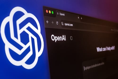 The OpenAI logo alongside a computer screen displaying the ChatGPT and OpenAI website.