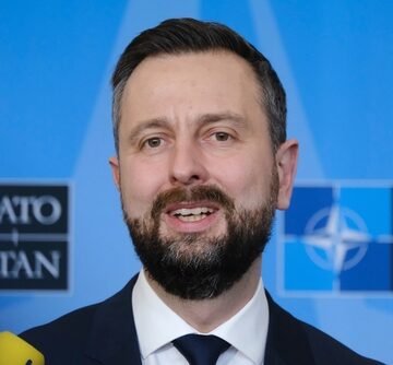 Władysław Kosiniak-Kamysz, the Deputy Prime Minister and Minister of National Defence of Poland, speaks at a press conference against a NATO backdrop.