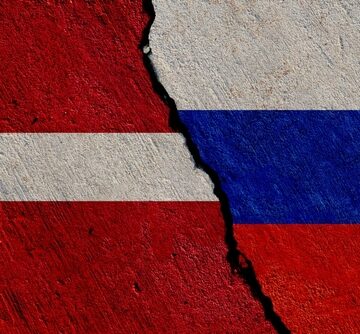 Latvian,And,Russian,Flags,Painted,On,Concrete,Wall,,Latvia,Russia NEW LATVIAN PM WANTS EUROPE TO BAN RUSSIANS FROM OBTAINING VISAS