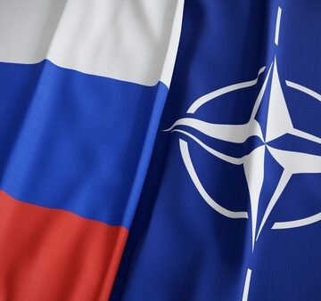 The national flag of Russia alongside the flag of the North Atlantic Treaty Organization (NATO). The national flag of Russia alongside the flag of the North Atlantic Treaty Organization (NATO).